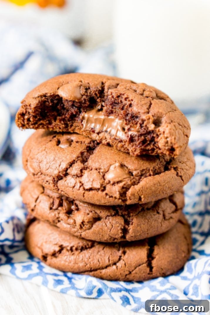 These Nutella Stuffed Cookies are a delicious double chocolate chip cookie that's laced with Nutella and stuffed with a gooey hazelnut chocolate filling.