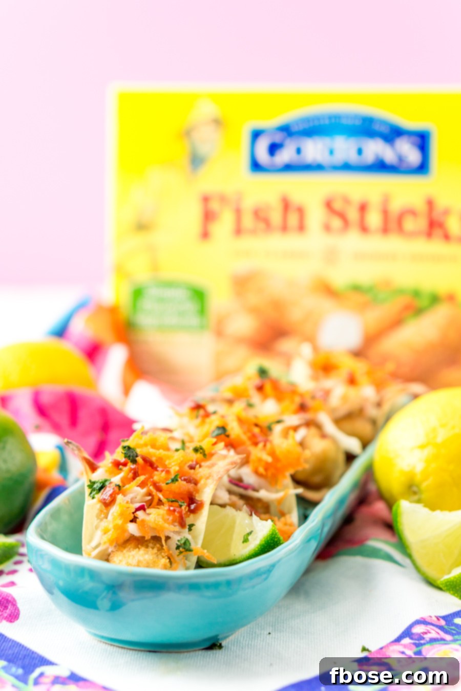 A vibrant spread of Fish Stick Tacos and accompanying sauces and toppings.