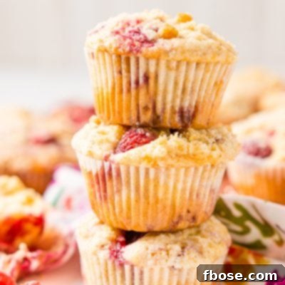 Raspberry Muffins loaded with juicy red raspberries and topped with an irresistible sugar crumble.