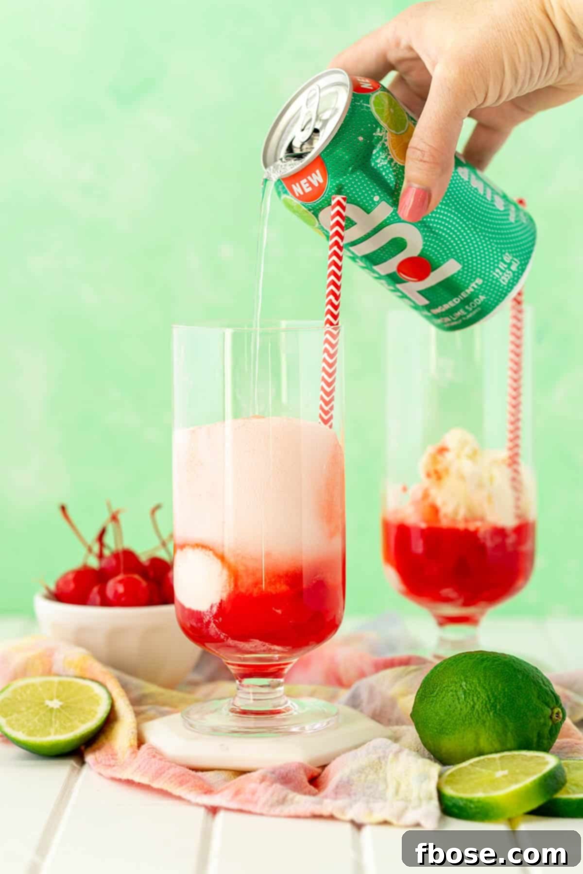 A can of 7Up being poured into a glass with vanilla ice cream and grenadine syrup.