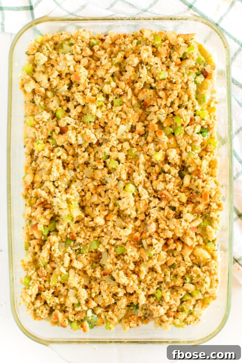 Overhead photo of a casserole dish filled with steaming Broccoli Cheese Casserole, showcasing its rich, golden-brown topping and bubbling cheese.