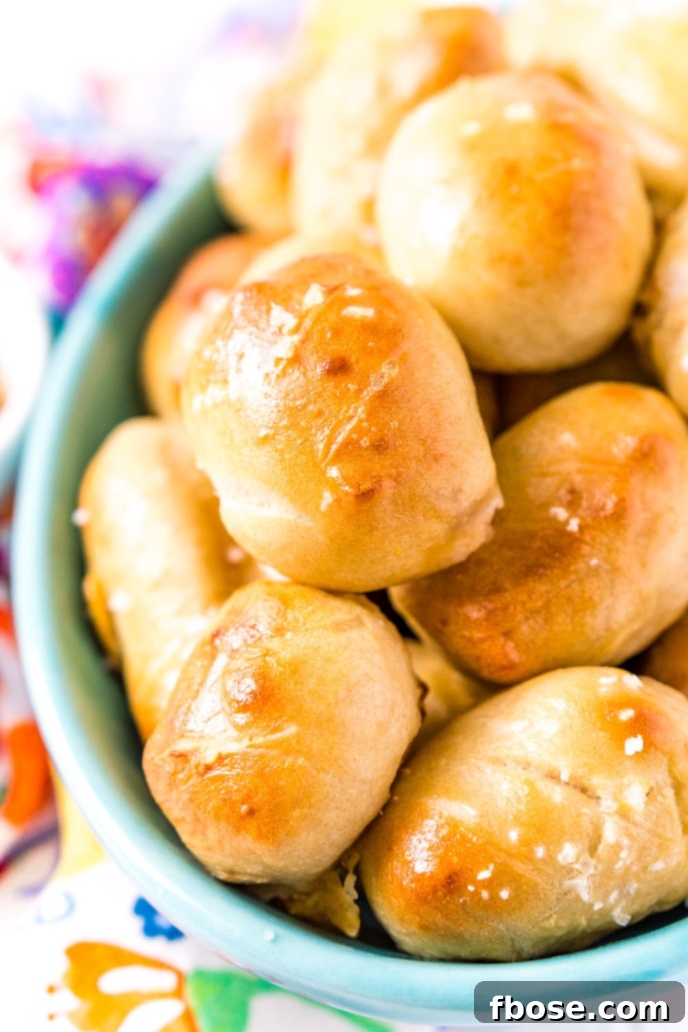 These Pretzel Pigs In A Blanket take two of your favorite party foods and combine them into one! Mini sausages and cheddar cheese wrapped in dough and baked to perfection!