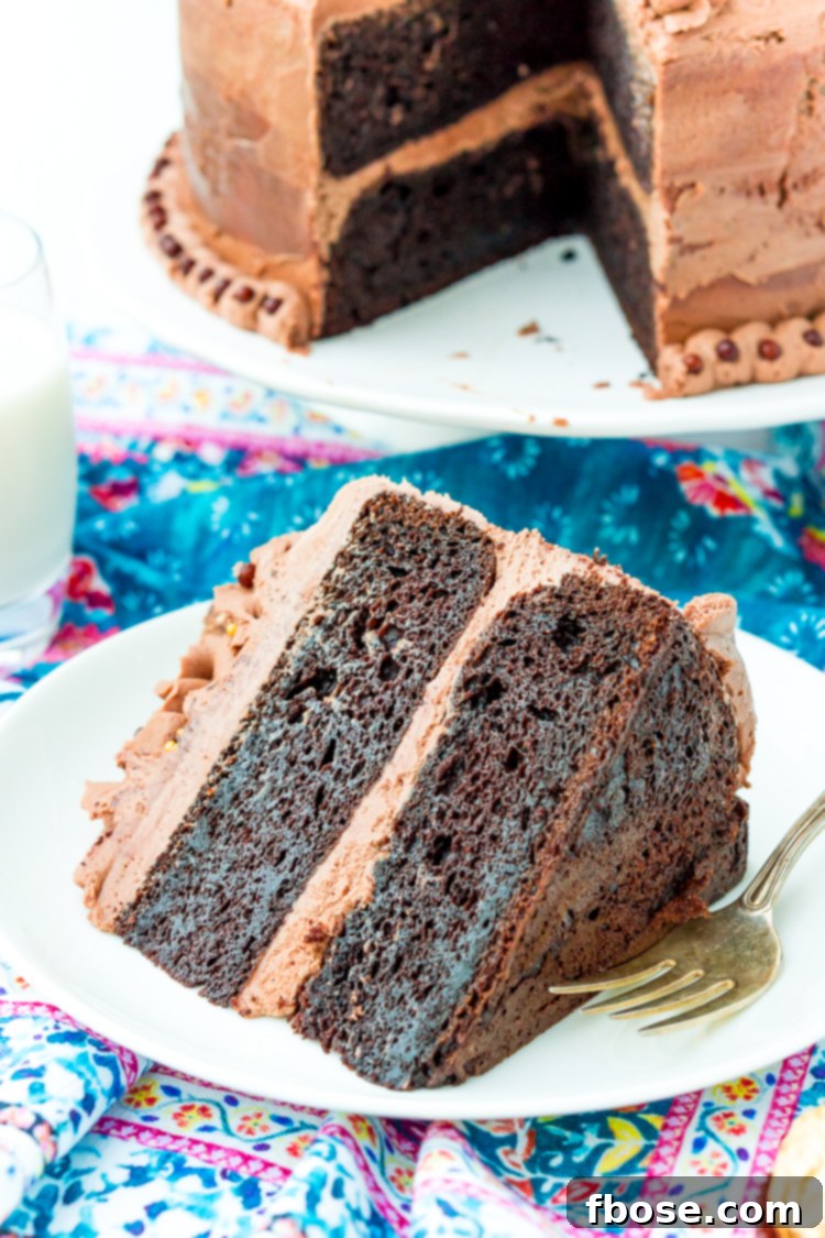 A perfectly portioned slice of Nutella cake presented on a white plate with a silver fork beside it, inviting a taste.