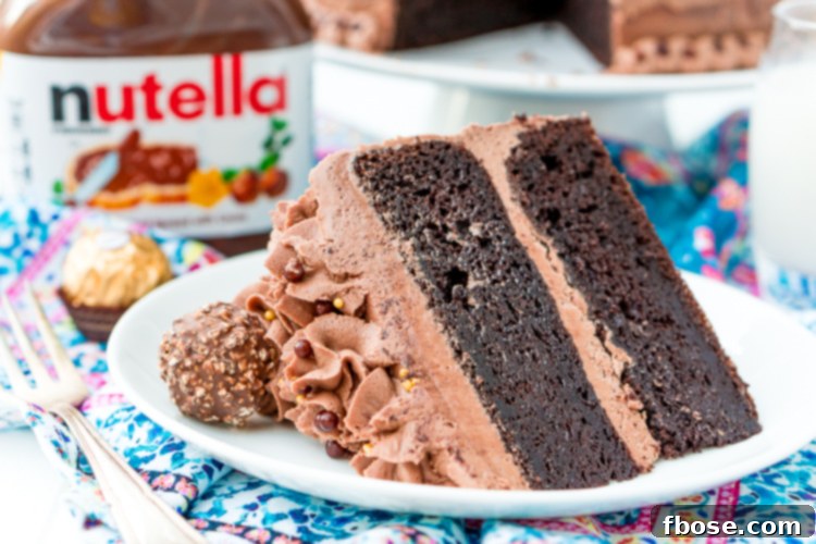Another enticing view of a slice of Nutella cake on a white plate, with a fork nearby, ready to be enjoyed.