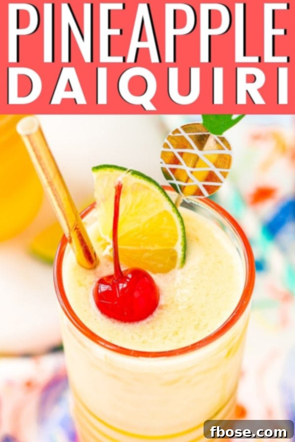 Tropical Pineapple Daiquiri 5 A beautifully composed flat lay image featuring a garnished Pineapple Daiquiri alongside fresh pineapple slices, evoking a sense of tropical refreshment.