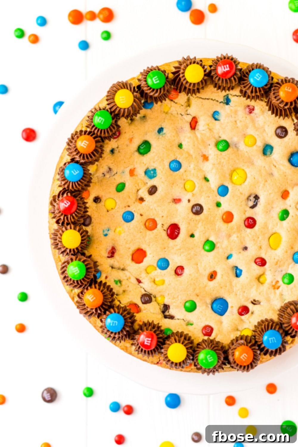 Overhead of M&M's Cookie Cake on white background.