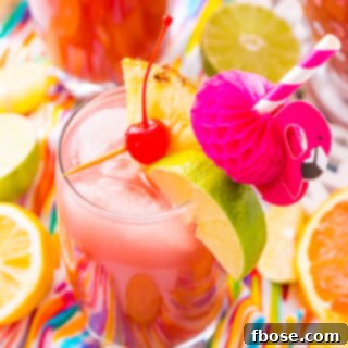 Rum Punch combines orange, pineapple, lime, and lemon juice with ginger ale and three different kinds of rum for a delicious large batch Caribbean inspired cocktail for summer parties!