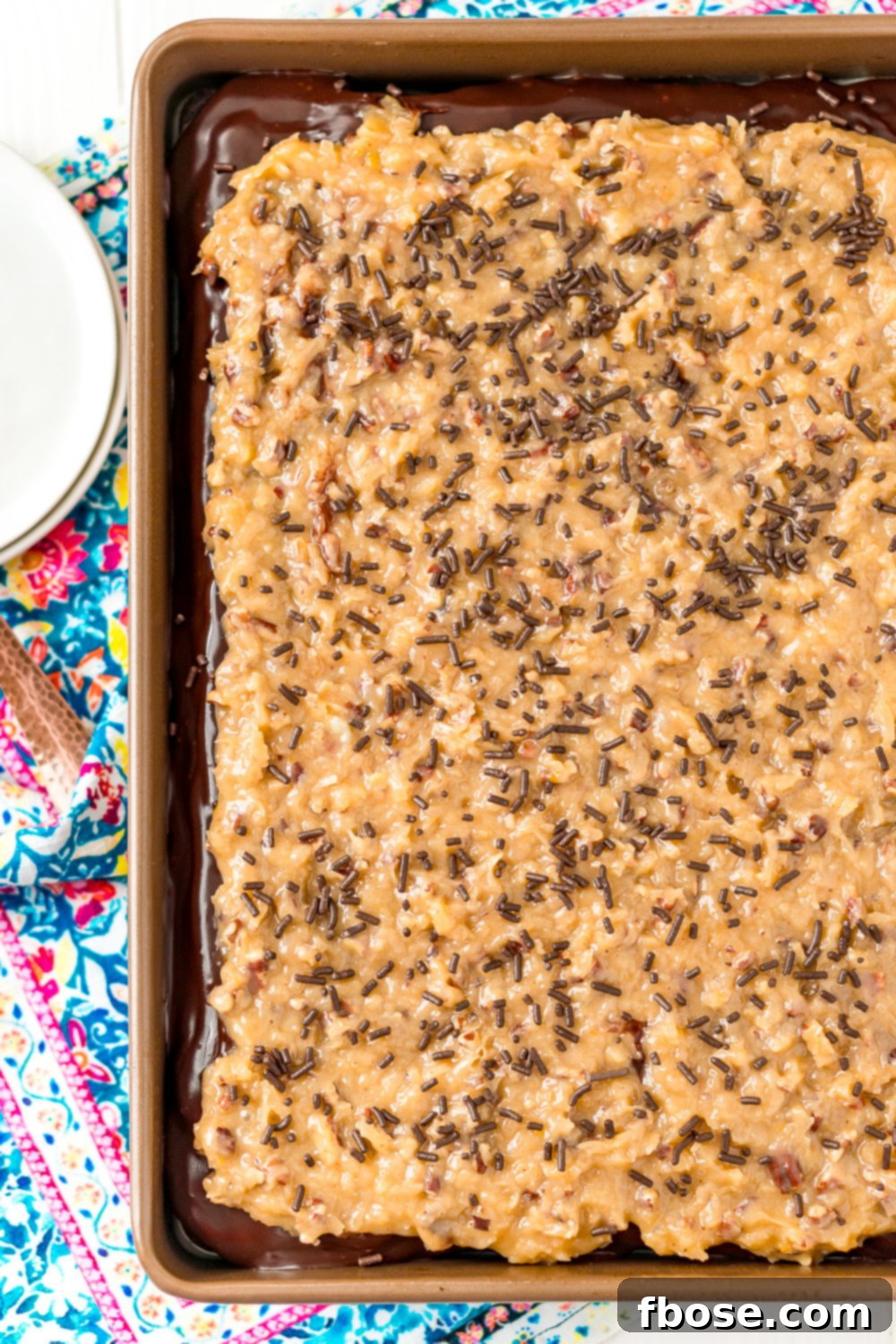 Overhead shot of a German Chocolate Poke Cake in a 9x13-inch pan.