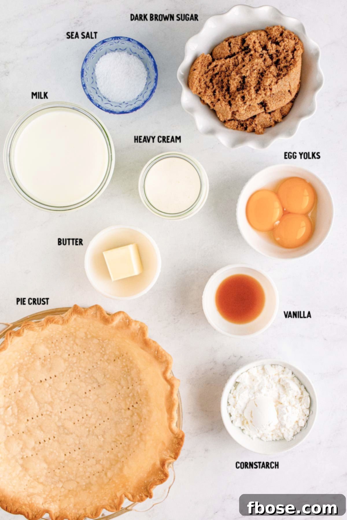 Overhead photo of ingredients to make butterscotch pie prepped on a marble counter.