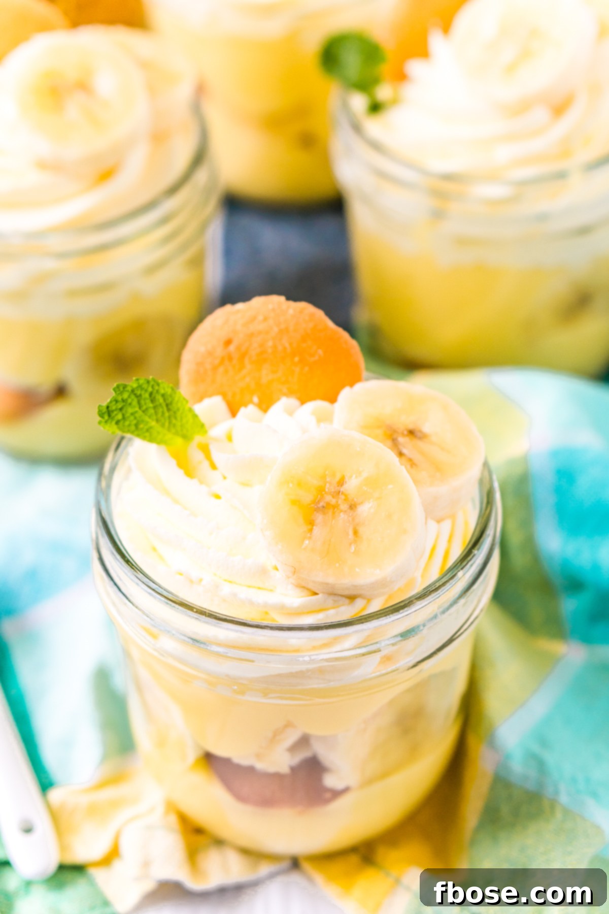 Mini mason jars filled with banana pudding dessert.