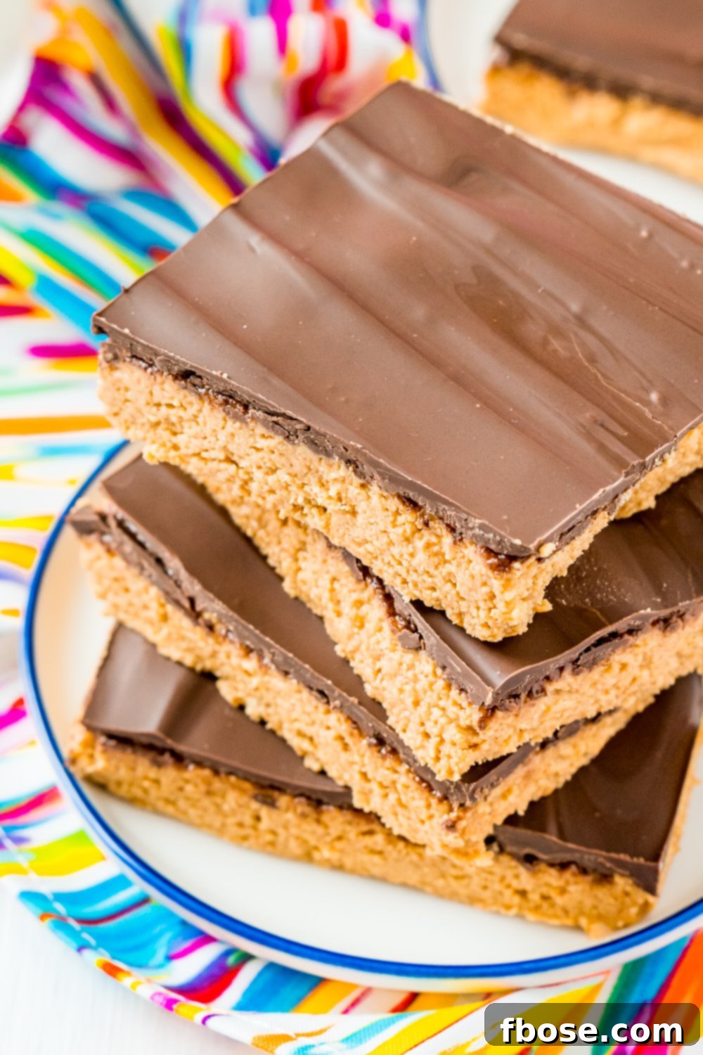 Peanut Butter Bars are a classic, 5-ingredient dessert recipe that can be made in less than 10 minutes! Made with a blend of peanut butter, graham crackers, powdered sugar, butter, and chocolate!