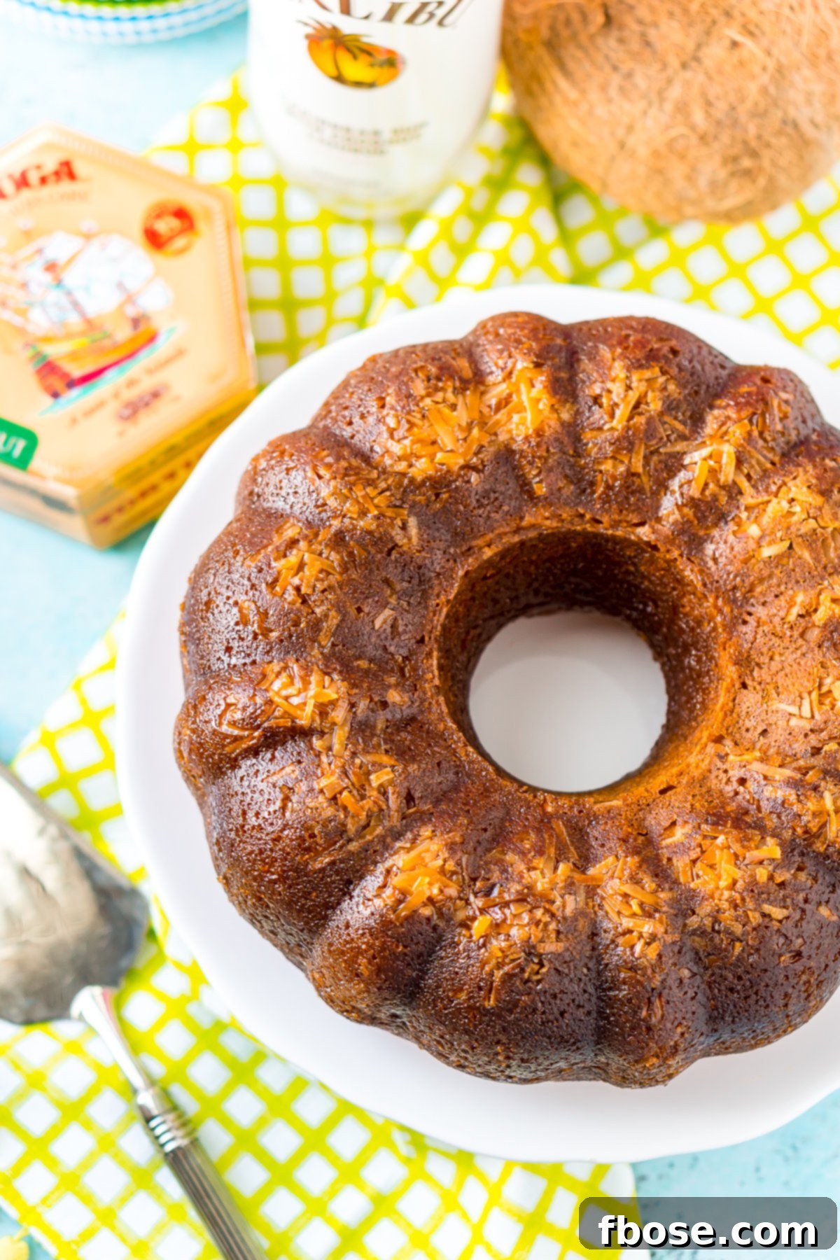 Caribbean Coconut Rum Bliss 6 Overhead shot of a bundt rum cake on a white cake stand.