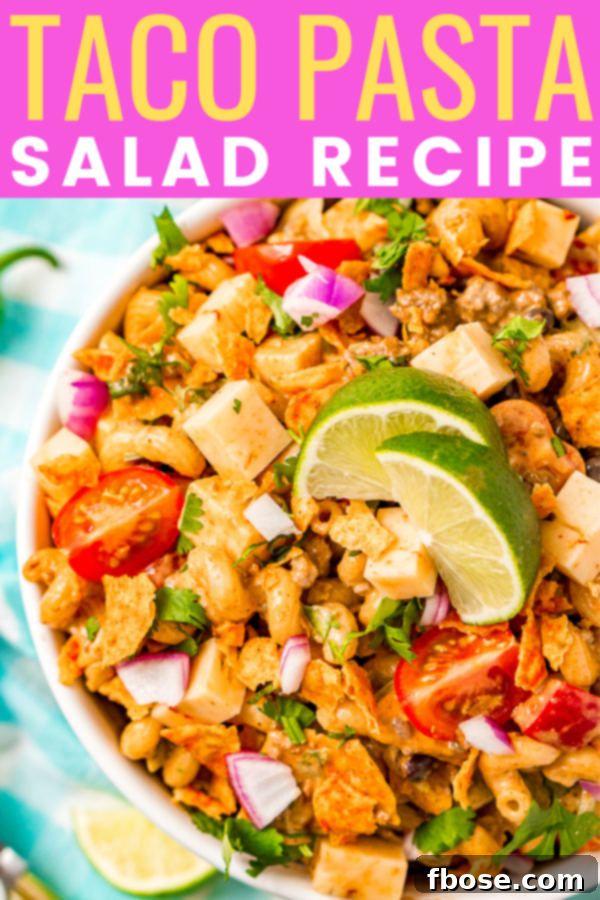 A beautifully composed image of Taco Pasta Salad with Doritos, highlighting the zesty blend of Mexican spices, ground beef, fresh vegetables, creamy chipotle dressing, and crunchy tortilla chips. Perfect for summer gatherings.