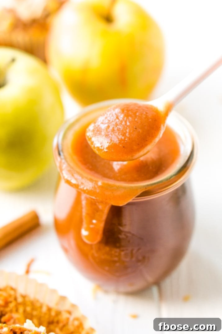 Jarred Homemade Crockpot Apple Butter, ready for gifting or long-term storage, showcasing its rich texture and color.