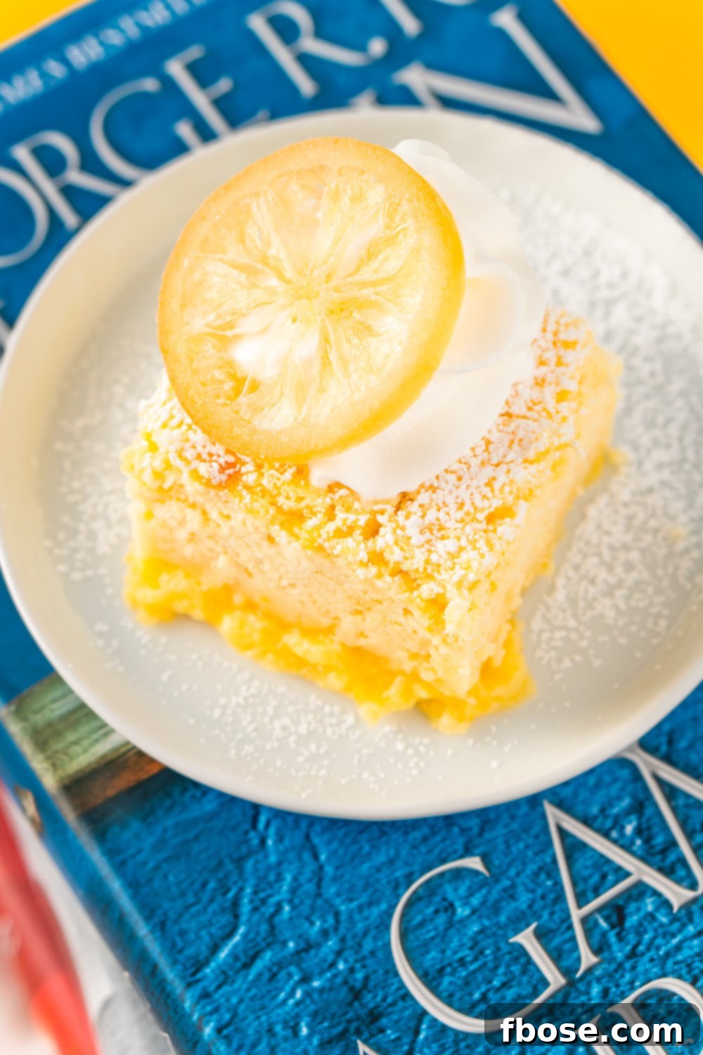 Slice of Sansa's Lemon Cake on a Game Of Thrones Book.