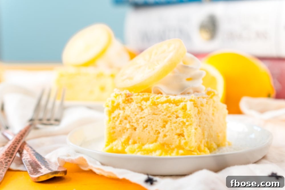 Horizontal photo of a piece of Lemon Magic Cake on a white plate with forks next to it.