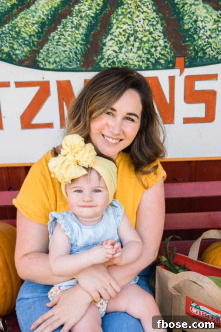 Slow Cooked Cheesy Corn Comfort 3 Mother an infant daughter sitting on a bench at a farm stand.