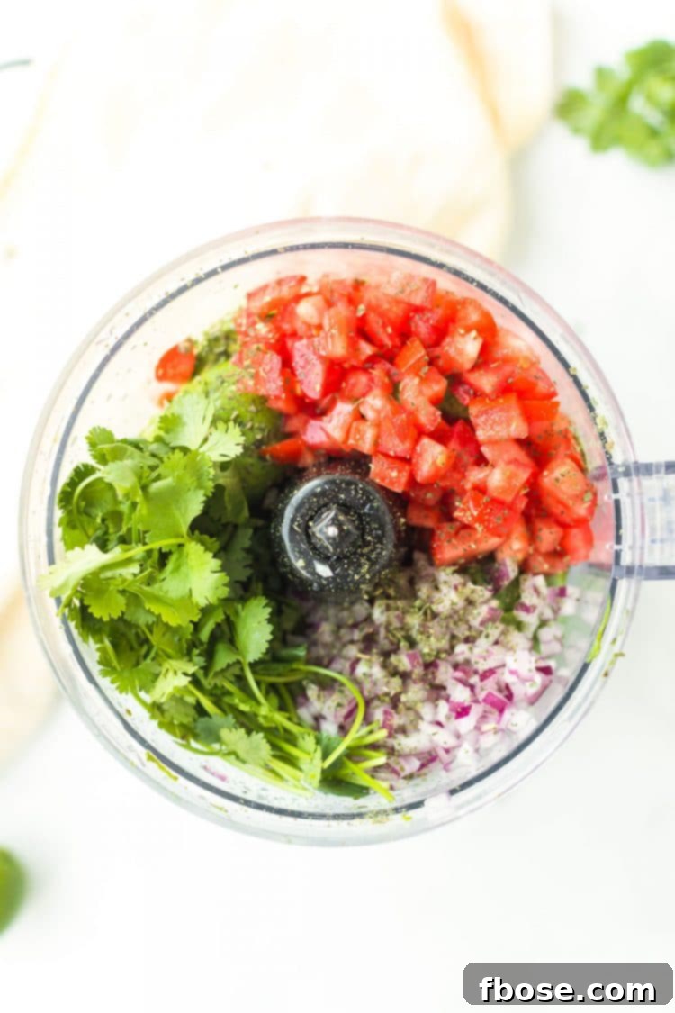 Guacamole 4 Herbs, onions, and tomatoes in a food processor.