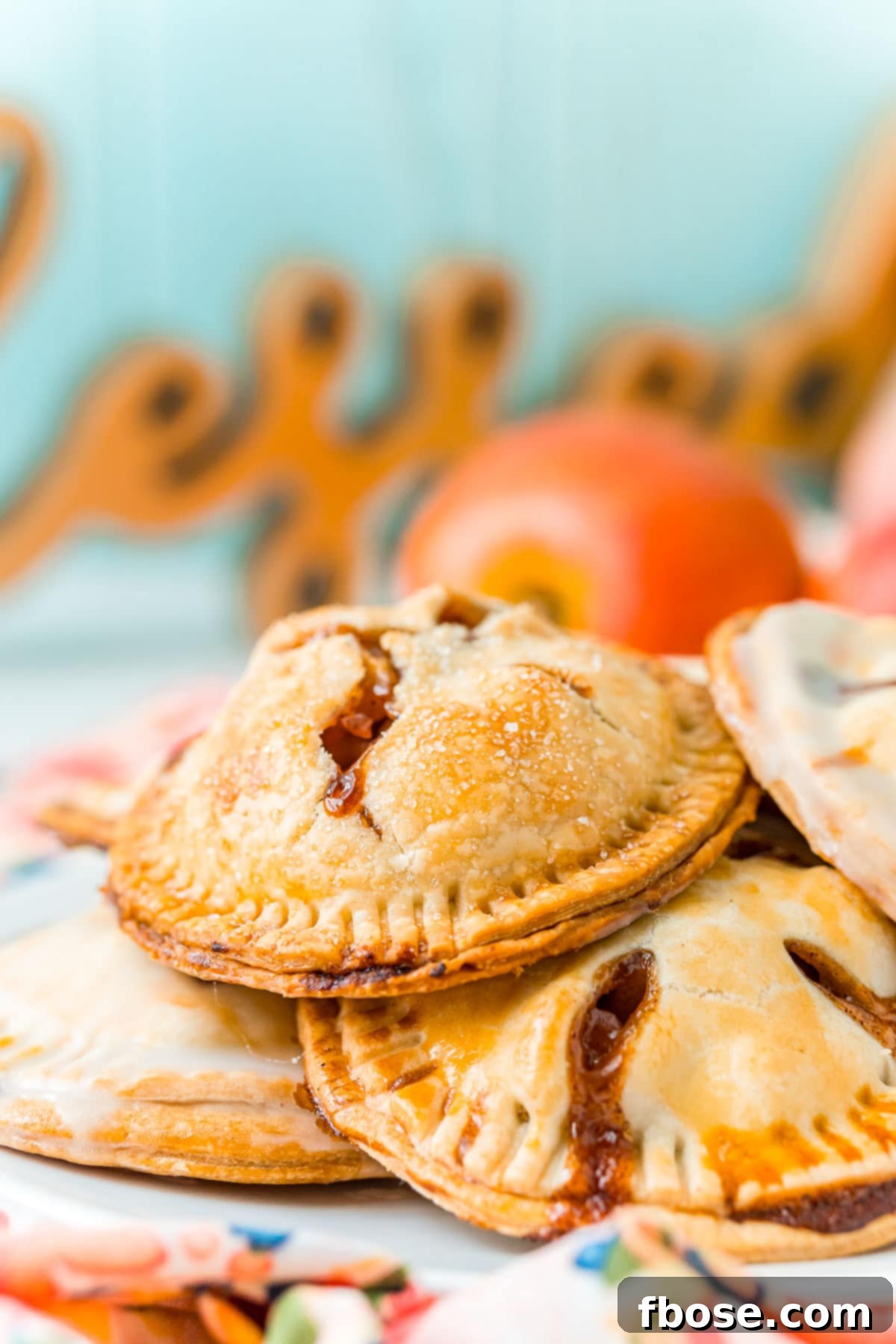 Golden Apple Hand Pies 3 Hand pies piled on a white plate.