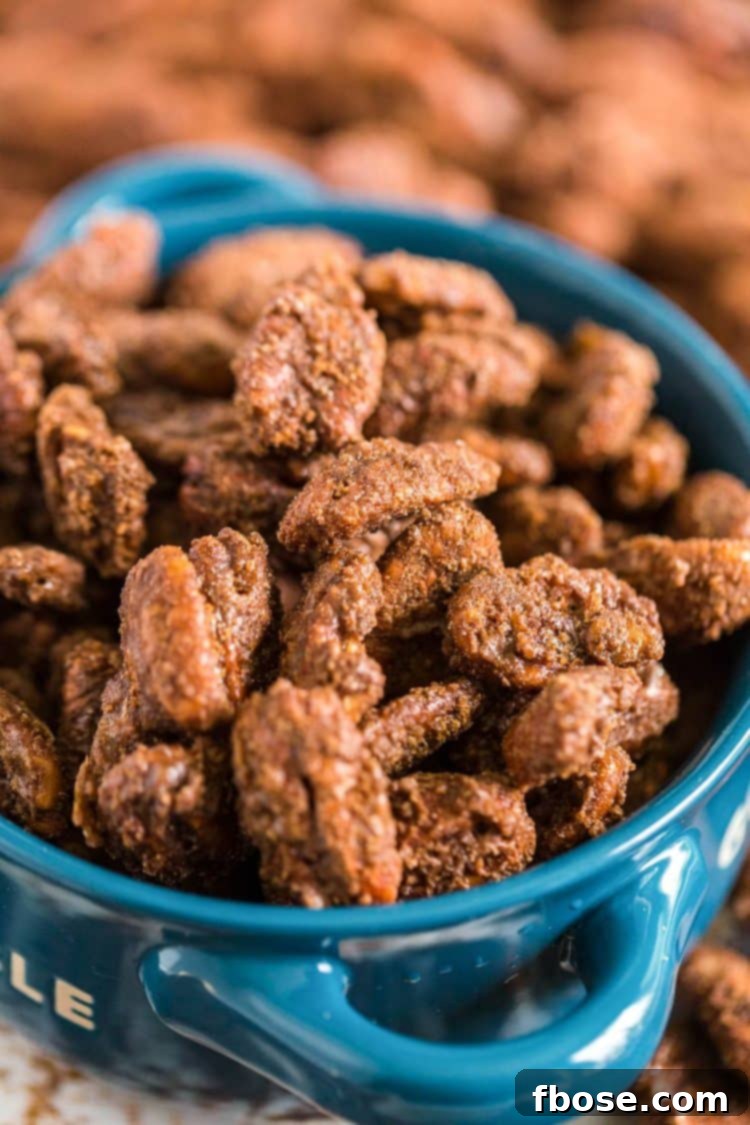 Gingerbread Candied Pecans in a blue serving bowl, ready to be enjoyed.