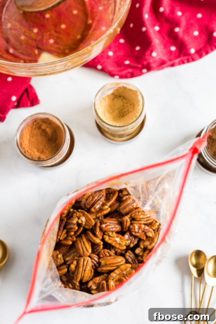 Pecans in a ziploc bag being shaken with sugar and spices for a complete coating.
