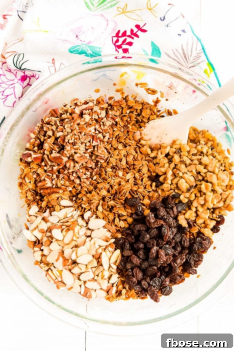 Nuts and raisins being added to toasted oats to make granola.