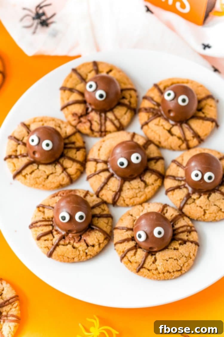 Halloween spider cookies on a white plate to serve at a party.