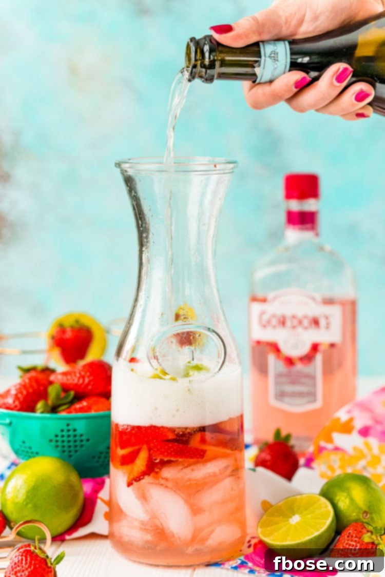 Prosecco being poured into a carafe.