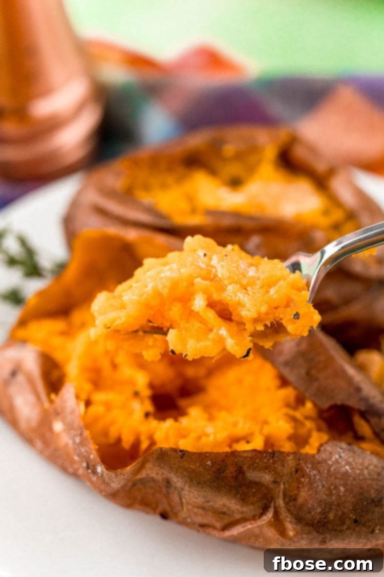 A fork full of baked sweet potato.