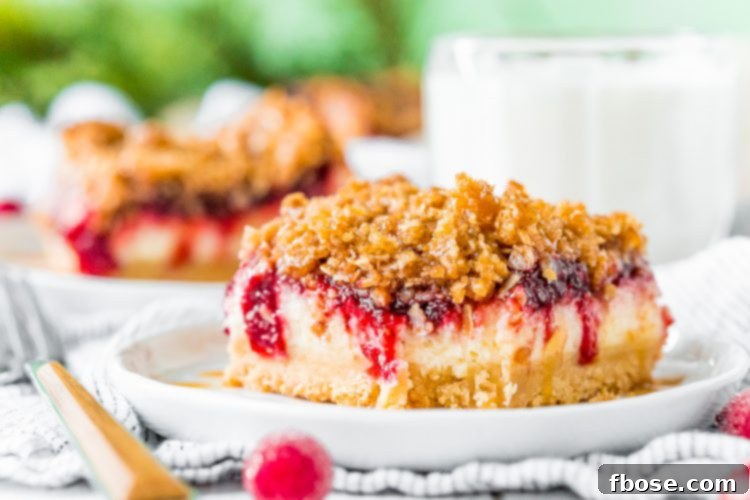 Close up photo of cranberry cheesecake bars with a bite taken out of it.