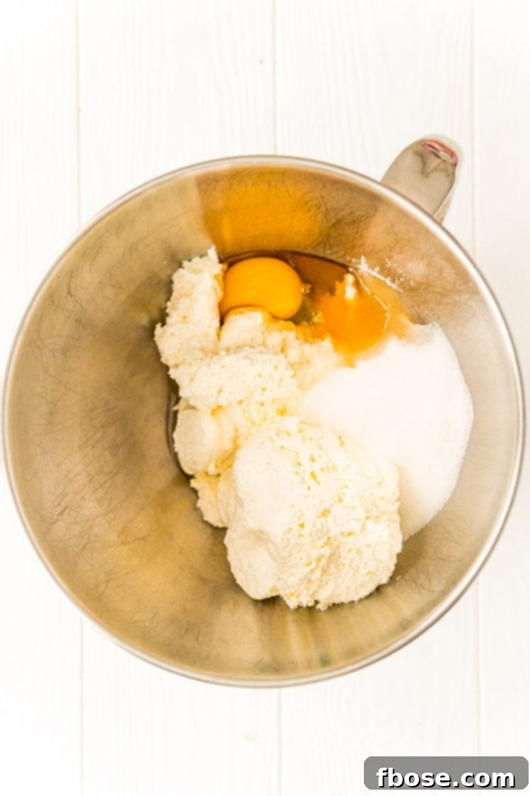 Ingredients to make a cheesecake filling in a mixing bowl.