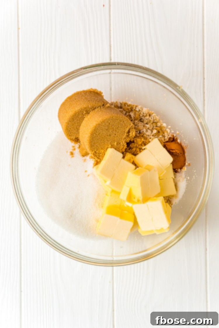 Ingredients to make an oatmeal crumble topping in a large glass bowl.
