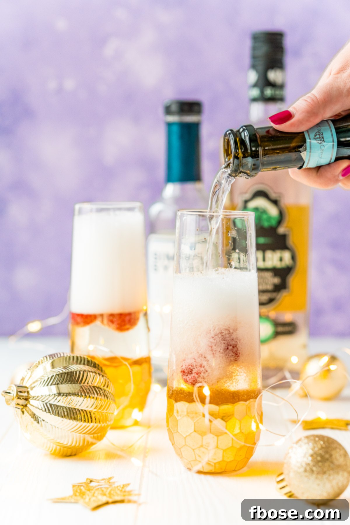 Golden Bloom Fizz 5 Woman's hand pouring champagne into a flute.