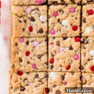 Overhead photo of a batch of sliced chocolate chip cookie bars on parchment paper.