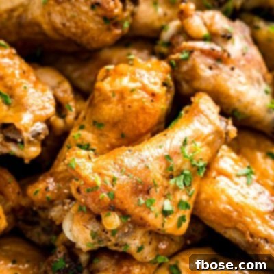 Crispy Oven Baked Wings 7 Chicken wings piled on top of each other in a bowl ready to eat.