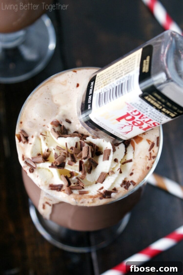 Black Cherry Hot Chocolate with empty small container of red stag bourbon upended into it, emphasizing the bourbon component.