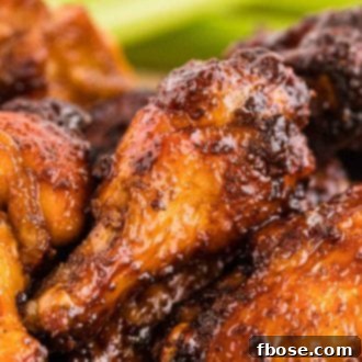 Close up photo of chicken wings with a sticky sauce on them.
