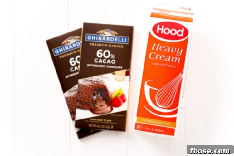 Close-up shot of the two essential ingredients for chocolate ganache: a bar of dark chocolate and a carton of heavy cream.