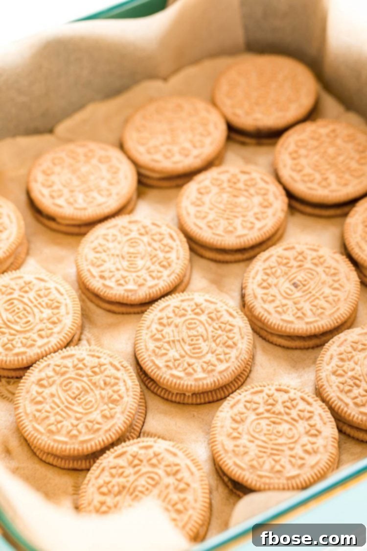 Close-up photo of Chocolate Peanut Butter Pie Oreos carefully placed on top of peanut butter cookie dough in a baking dish.