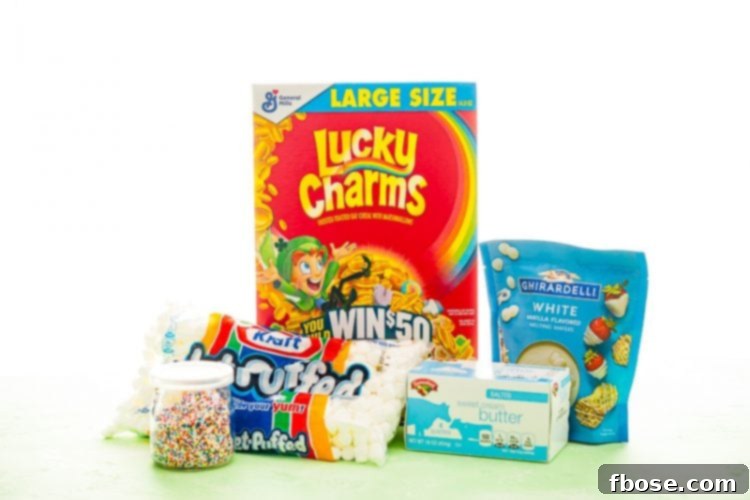 Photo of ingredients to make lucky charms treats including sprinkles, marshmallows, lucky charms cereal, butter, and white chocolate.