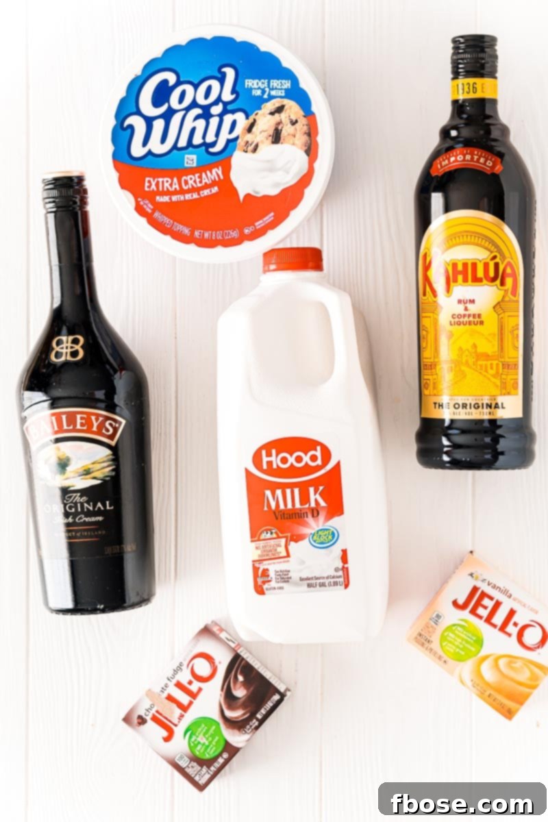 Overhead photo showing all the ingredients neatly laid out for making pudding shots, including instant pudding mix, milk, alcohol, and Cool Whip.