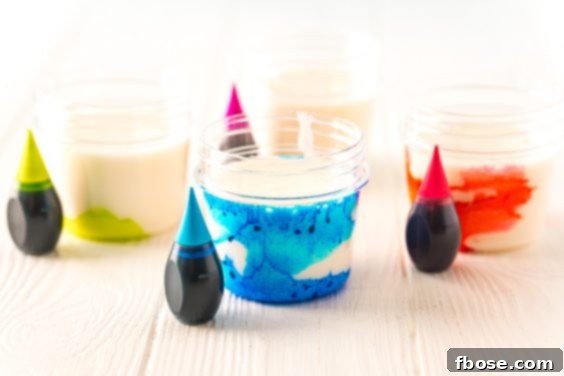 Bath paint with food coloring being added to color it.