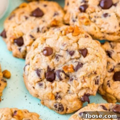 Chocolate chip walnut cookies piled on top of each other.