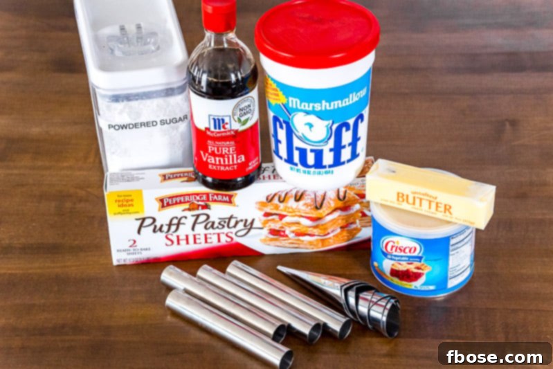 Close-up of ingredients for cream horns, including butter, shortening, powdered sugar, marshmallow fluff, and vanilla extract.