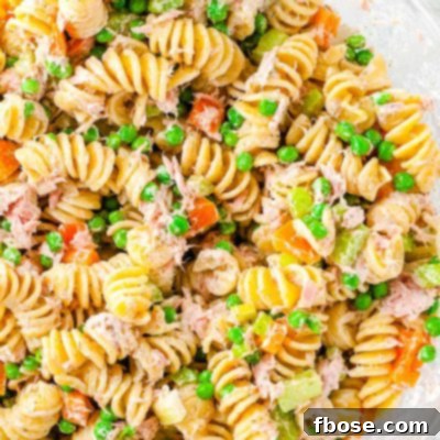 Overhead photo of tuna pasta salad in a clear glass bowl.
