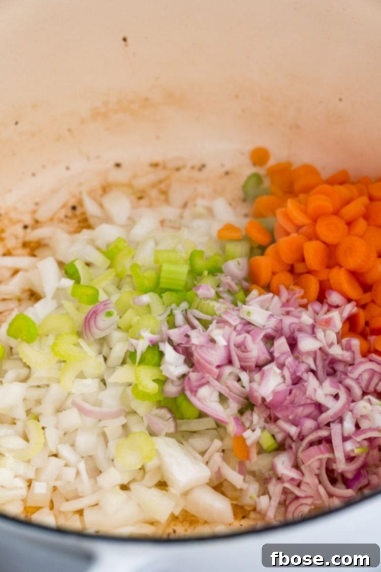 Freshly diced vegetables including celery, onions, shallots, and carrots, ready to be sautéed in a Dutch oven for the braised beef short ribs.