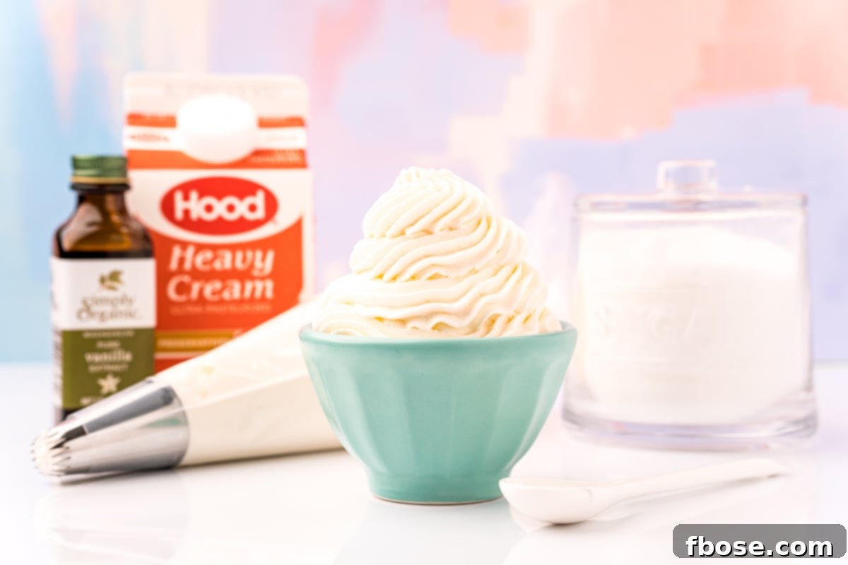 A small blue bowl filled with whipped cream with the ingredients to make it behind it.