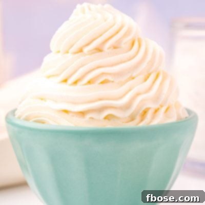 Close up photo of a light blue bowl that has whipped cream piped into it.