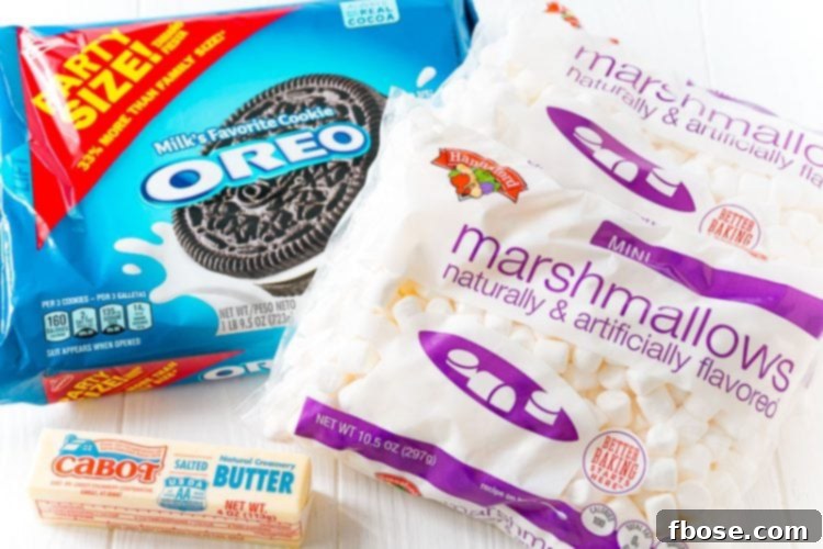ingredients to make marshmallow oreo treats on a white table.