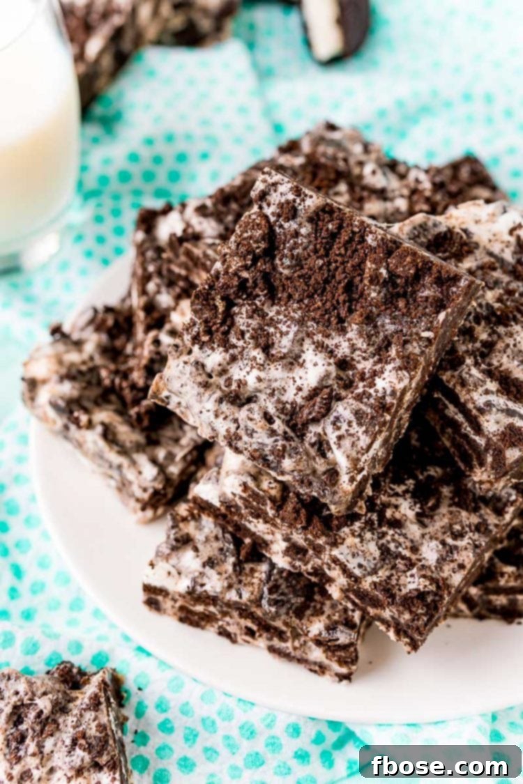Close up photo of oreo marshmallow treats on a white plate on a blue dotted napkin.